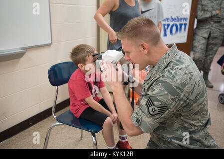 U.S. Air Force Staff Sgt. Jonathon Engler, an optometry technician from the unit 167th Medical Group, West Virginia Air National Guard, checks a child’s vision at Graves County High School in Mayfield, Ky., July 20, 2016, during Bluegrass Medical Innovative Readiness Training. The Kentucky Air National Guard, U.S. Navy Reserve and other military units are teaming with the Delta Regional Authority to offer medical and dental care at no cost to residents in Mayfield and two other Western Kentucky locations from July 18 to 27 as part of the training event. (U.S. Air National Guard photo by Master Stock Photo