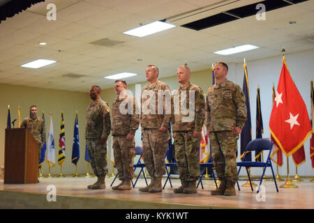 Command Sgt. Maj. Ronald Howell, command sergeant major of the 116th MET, Col. Todd Hubbard, commander of the 116th MET, Maj. Gen. William B. Hickman, deputy commanding general of operations for 3rd Army/U.S. Army Central, Lt. Col. Joseph Gardner, commander of the 149th MET, and Command Sgt. Maj. Jesse Withers, command sergeant major of the 149th MET, take their place on stage as the official party during the Transfer of Authority Ceremony Jan. 9 at Camp Arifjan, Kuwait. Stock Photo