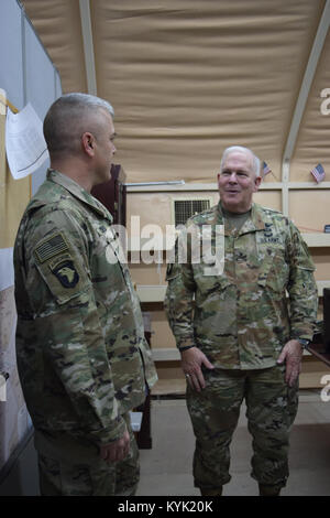 Brig. Gen. Benjamin Adams III, Kentucky's Director of the Joint Staff, visits with Maj. Daniel Cooper, 149th Military Engagement Team operations officer, Mar. 3 during a trip to Camp Arifjan, Kuwait. Stock Photo