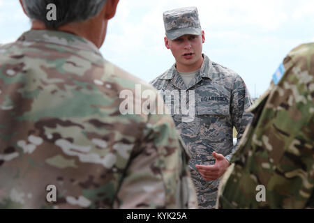 Kentucky Air National Guardsman, Airman First Class Thomas Hale from Palmyra, Indiana briefed a group of distinguished visitors on what the CBRNE Enhanced Response Force Package (CERFP) is and what his specific duties were. The distinguished visitors were a mixture of Georgia National Guard leaders,  the Republic of Georgia representatives, Argentinean representatives and United States government officials (U.S. Army photo by Sgt. First Class Rebecca Wood). Stock Photo