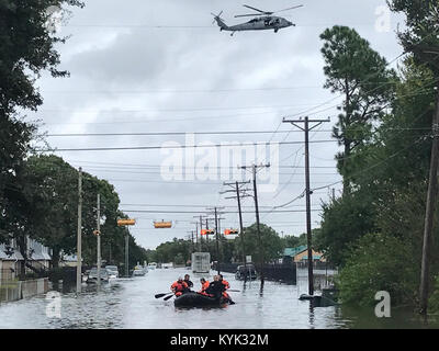 Kentucky Air National Guardsmen conduct water rescue missions in Port Arthur, Texas, Aug. 30, 2017, in the wake of Hurricane Harvey. The Airmen, assigned to the 123rd Special Tactics Squadron, are patrolling the area in motorboats, looking for people who are trapped in their homes or on rooftops because of the massive flooding. Once the residents are safely in the boats, the Airmen provide any necessary medical care and transport them to the nearest shelter. (U.S. Air National Guard photo) Stock Photo