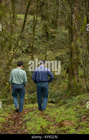 Twins Walking In The Woods Stock Photo