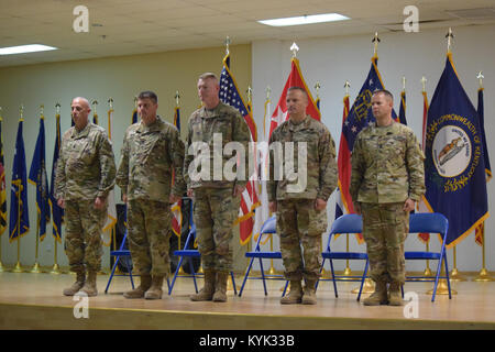 Maj. Gen. Terrence McKenrick, U.S. Army Central deputy commanding general, center, the 648th Military Engagement Team command team, left, and the 149th MET command team conduct a transfer of authority ceremony Sept. 6, 2017, at Camp Arifjan, Kuwait. McKenrick presided over the ceremony that signified the completion of the mission for the Kentucky National Guard's 149th MET and the assumption of the mission for the Georgia National Guard's 648th MET. Stock Photo