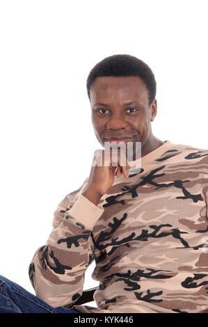 A happy and handsome African American man sitting with his hand on his chin in a sweeter, isolated for white background Stock Photo