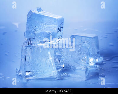 Blue toned ice cubes on wet surface Stock Photo