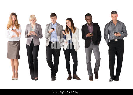Multi Ethnic Business People Using Cell Phones Against White Background Stock Photo