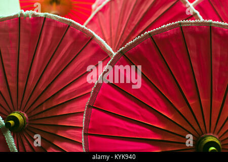 red color umbrellas close up, traditional asian craftsmanship in Chiangmai, Thailand Stock Photo
