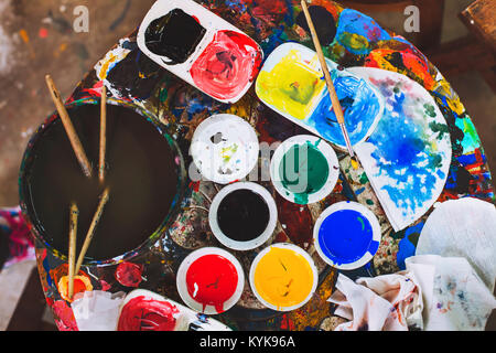 hobby and creativity concept, artist painter workplace, craftmanship, many different colors and brushes Stock Photo