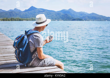tourist traveler using mobile phone, smartphone app for traveling Stock Photo