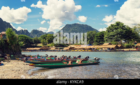 long tail boats on sunset at Song river, Vang Vieng, Laos. Stock Photo