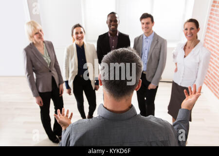 Rear View Of Manager With His Business Colleague In The Office Stock Photo