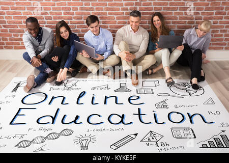 Group Of Happy Diverse People Looking At Online Education Plan Stock Photo