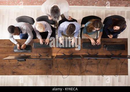 Overhead View Of Male Teacher With Student In The Computer Room Stock Photo