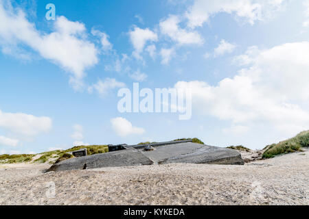 Ruin of a german bunker burried in the sand on a beach in Denmark on a summer day Stock Photo