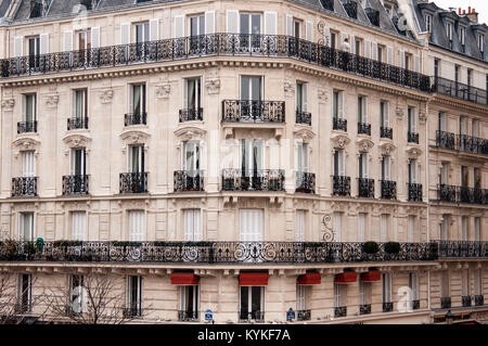 A Haussmann style building with black wrought iron railings on the ...