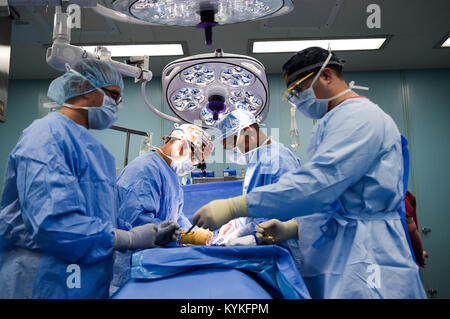 CARIBBEAN SEA (Oct. 18, 2017) –  Sailors embarked on the Military Sealift Command hospital ship USNS Comfort (T-AH 20), perform surgery on a patient in an operating room aboard the ship.  Comfort is underway operating in the vicinity of San Juan, Puerto Rico. The Department of Defense is supporting the Federal Emergency Management Agency, the lead federal agency, in helping those affected by Hurricane Maria to minimize suffering and is one component of the overall whole-of-government response effort. (U.S. Navy photo by Mass Communication Specialist 2nd Class Stephane Belcher/Released)171018-N Stock Photo