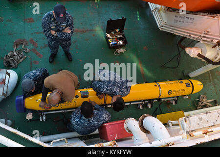 171125-N-TW634-055  ATLANTIC OCEAN (Nov. 25, 2017) Sailors assigned to Unmanned Undersea Vehicle Squadron 1 (UUVRON 1), mobilized with Undersea Rescue Command (URC), perform maintenance on a Bluefin-12D, an unmanned underwater vehicle, on board the Norwegian construction support vessel Skandi Patagonia near URC's submarine rescue chamber. Undersea Rescue Command, the U.S. Navy's only submarine rescue unit, is mobilized to support the Argentine government's search and rescue efforts for the Argentine Navy diesel-electric submarine A.R.A San Juan (S 42). (U.S. Navy photo by Mass Communication Sp Stock Photo