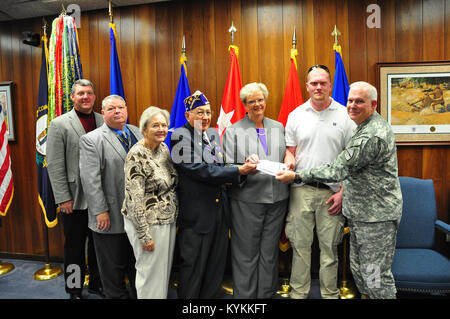 A Kentucky chapter for Purple Heart veterans presented a check Nov. 12 for the Kentucky National Guard Memorial that is currently raising funds to be built outside the Boone National Guard center in Frankfort, Ky. From left to right, Mr. Freddie Maggard, Mr. John Trowbridge, Ms. Christene Napier, Leroy Spaulding, Judy Spaulding, Charles Rawlings (Commander of the organization) and Brig Gen. Ben Adams. (US Army National Guard photo by Capt. Stephen Martin). Stock Photo
