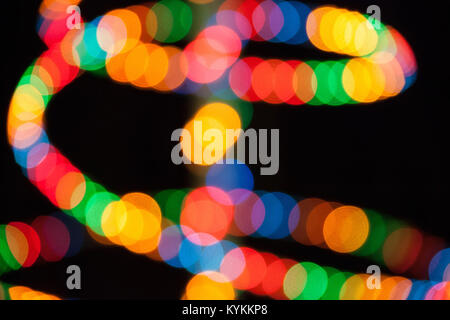 Rainbow multicolored lights blurred on black background Stock Photo