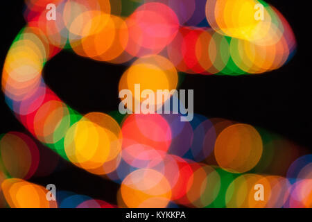 Rainbow multicolored lights blurred on black background Stock Photo