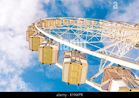 Looking up at a huge ferris wheel against blue sky and white clouds. Called the Grand Roue, a Christmas tradition in Paris, France Stock Photo