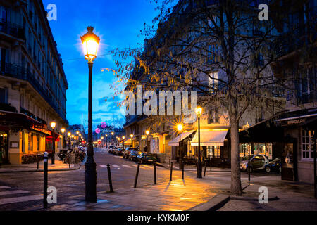 PARIS-JAN 5, 2014: Paris street decorated for the Christmas holiday in one of the oldest neighborhoods in the city, on the island Ile Saint-Louis. Stock Photo