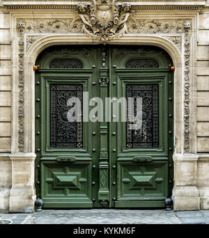 Paris old wooden doors painted green. Grand, ornate, double Stock Photo