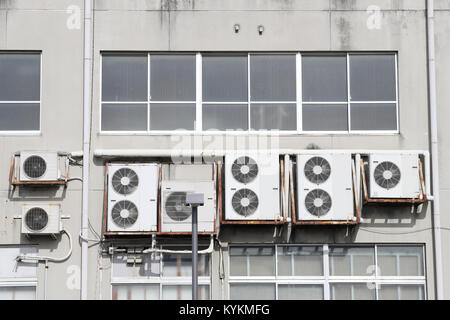 Air conditioners on the wall, Many compressor airs are hanging on a wall Stock Photo