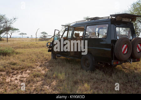 A safari vehicle out on the plains in Serengeti National Park (Land Cruiser) Stock Photo