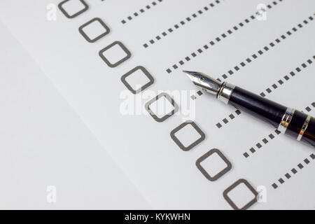 Check boxes on white paper with pen - closeup Stock Photo