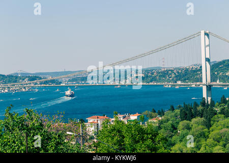 Landscape view of 15 July Martyrs Bridge or unofficially Bosphorus Bridge also called First Bridge over bosphorus with blue sky from Fethi Pasha Park  Stock Photo