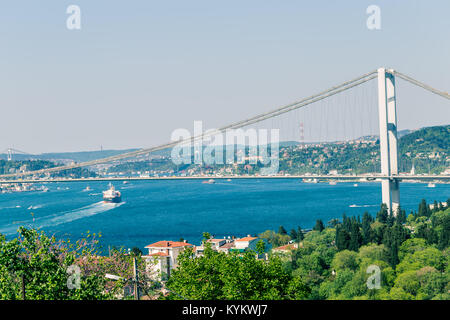 Landscape view of 15 July Martyrs Bridge or unofficially Bosphorus Bridge also called First Bridge over bosphorus with blue sky from Fethi Pasha Park  Stock Photo