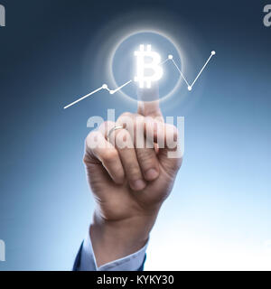 the man clicks Icon Bitcoin on virtual screen. Stock Photo