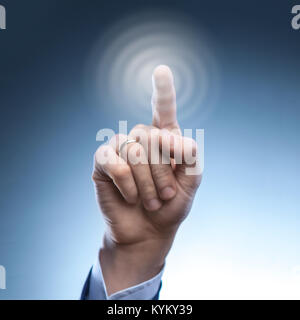 hand of a man presses the button on the virtual screen Stock Photo
