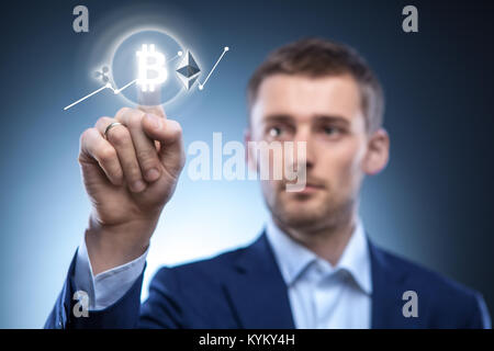 the man clicks Icon Bitcoin on virtual screen. Stock Photo