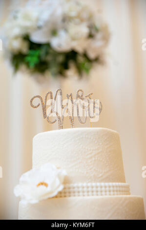 A wedding cake topper, reading "Mr. & Mrs", on a beautiful cake Stock Photo