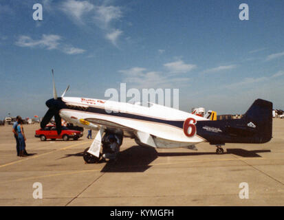 This image showcases various North American P-51 Mustangs, including aircraft with registration numbers CF-MWC, N351DT, N51VC, and others. These historic air racers were powered by Packard Merlin engines and were used in military aviation. Stock Photo