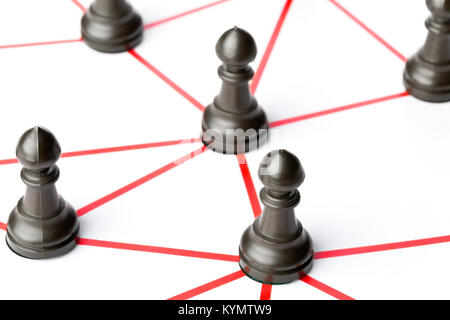 Chess pawn figures connected by red lines over white background - teamwork, connections or social network concept Stock Photo