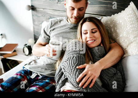 Couple embracing in their bedroom Stock Photo