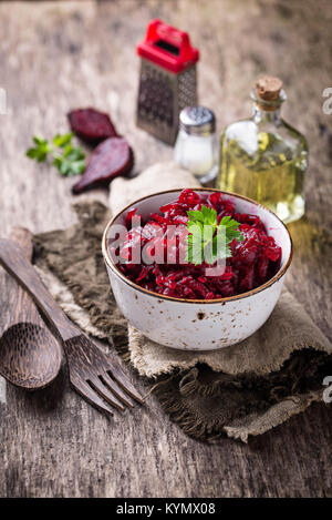Bowl of beetroot salad on wooden background Stock Photo