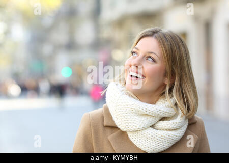 Portrait of a happy woman looking at side on the street in winter Stock Photo