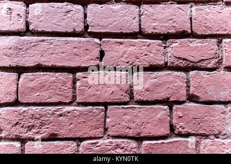 Wall of baked bricks colored in deep pink Stock Photo