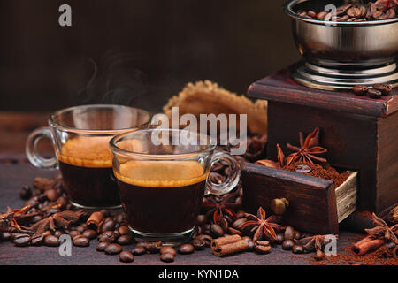 Coffee beans and grinder on wooden table  with cinnamon and anise stars. Stock Photo