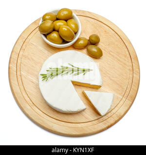 Round brie or camambert cheese on cutting board white background Stock Photo