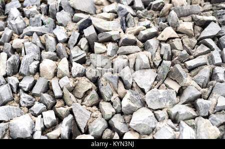 Grey triangle shaped rock chippings and stones in a triangle shapes with sharp edges used as a building exterior design feature Stock Photo