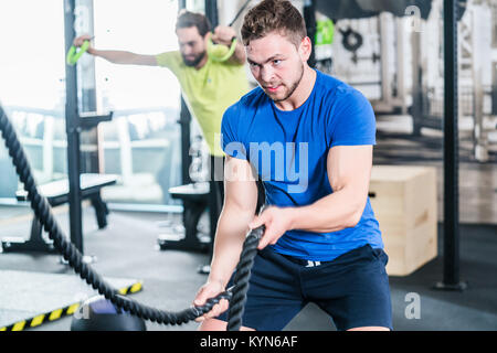 People in gym doing sport in functional fitness training Stock Photo