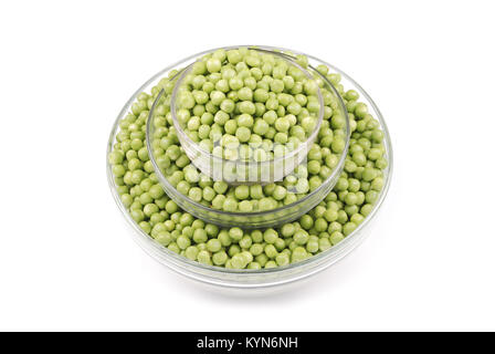 Green small spherical seeds of the pod fruit Pisum sativum, an edible legume. Isolated macro food photo close up from above on white background. Stock Photo