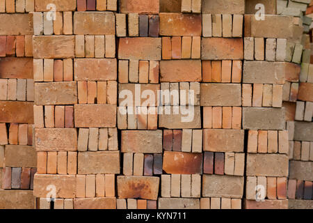 Basic red house bricks stacked in a pattern viewed straight on. Stock Photo