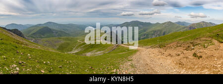 Walking down from Mount Snowdon on the Llanberis Path, Snowdonia, Gwynedd, Wales, UK - looking north towards the Clogwyn station, Llyn Padarn and Llan Stock Photo