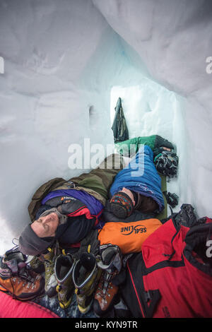 Sleeping in the snow hole.©Paul Glendell Stock Photo